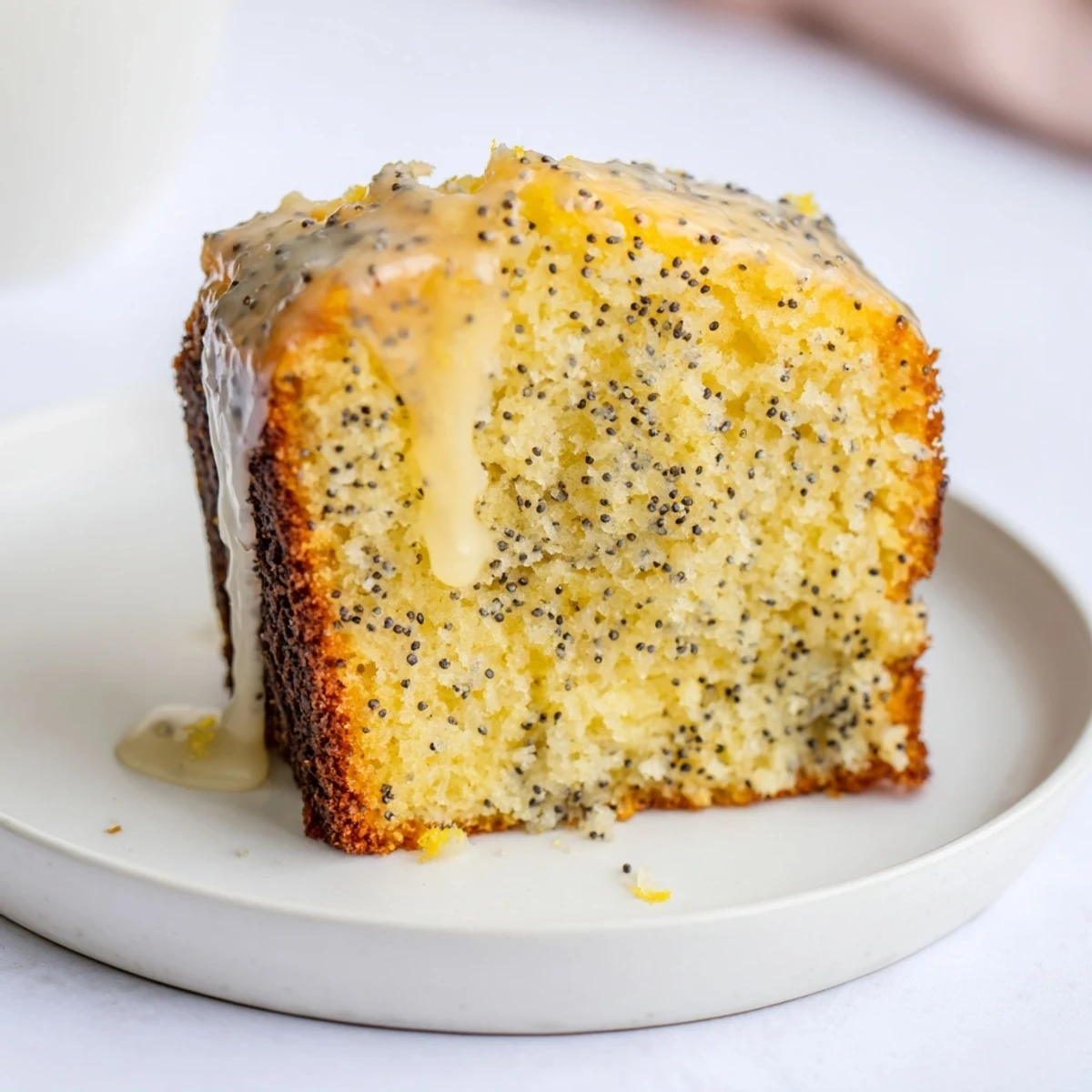 Moist Glazed Lemon Poppy Seed Cake slices, drizzled with a sweet, tangy glaze for a delicious treat.