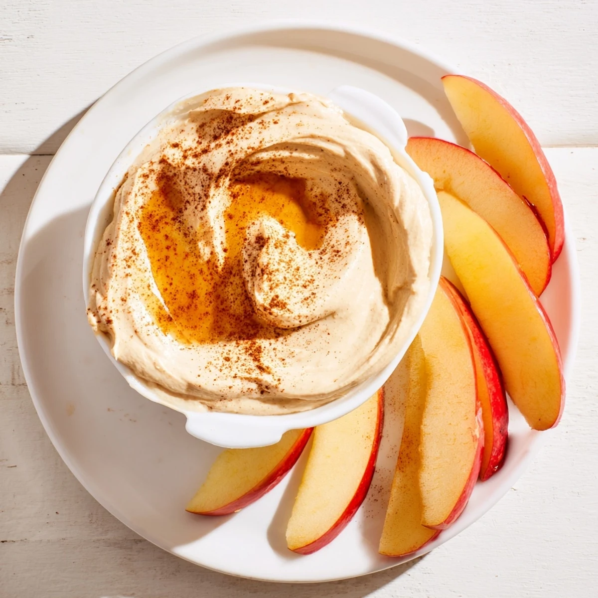 Close-up of apple slices with peanut butter dip, a healthy and tasty American snack option.