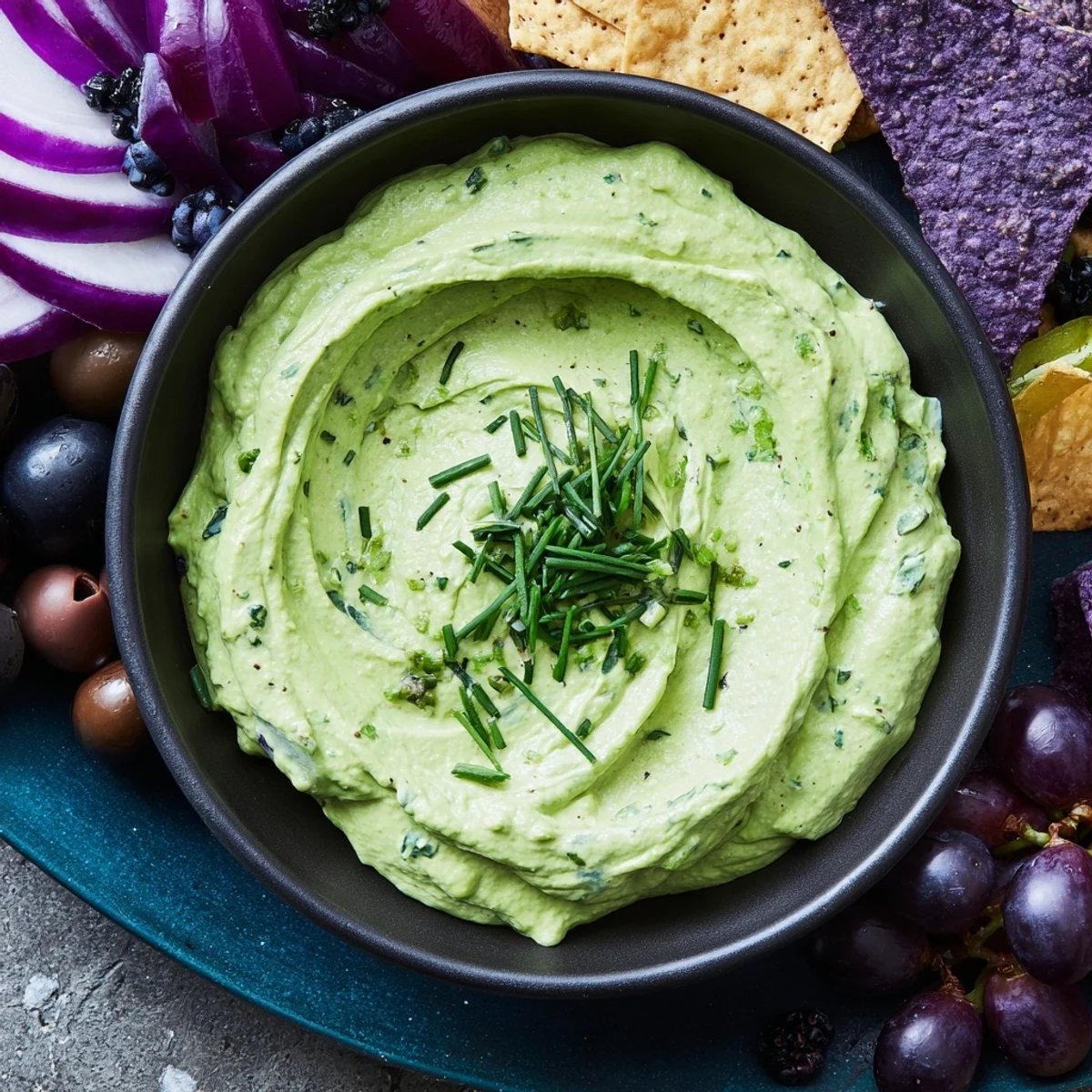 Witch's Brew Cauldron dip, a spooky Halloween appetizer, served in a black cauldron-shaped bowl.