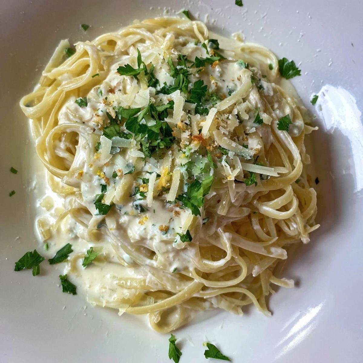 A close-up of the flavorful Lemon-Garlic Greek Yogurt Pasta, ready to serve with Parmesan.