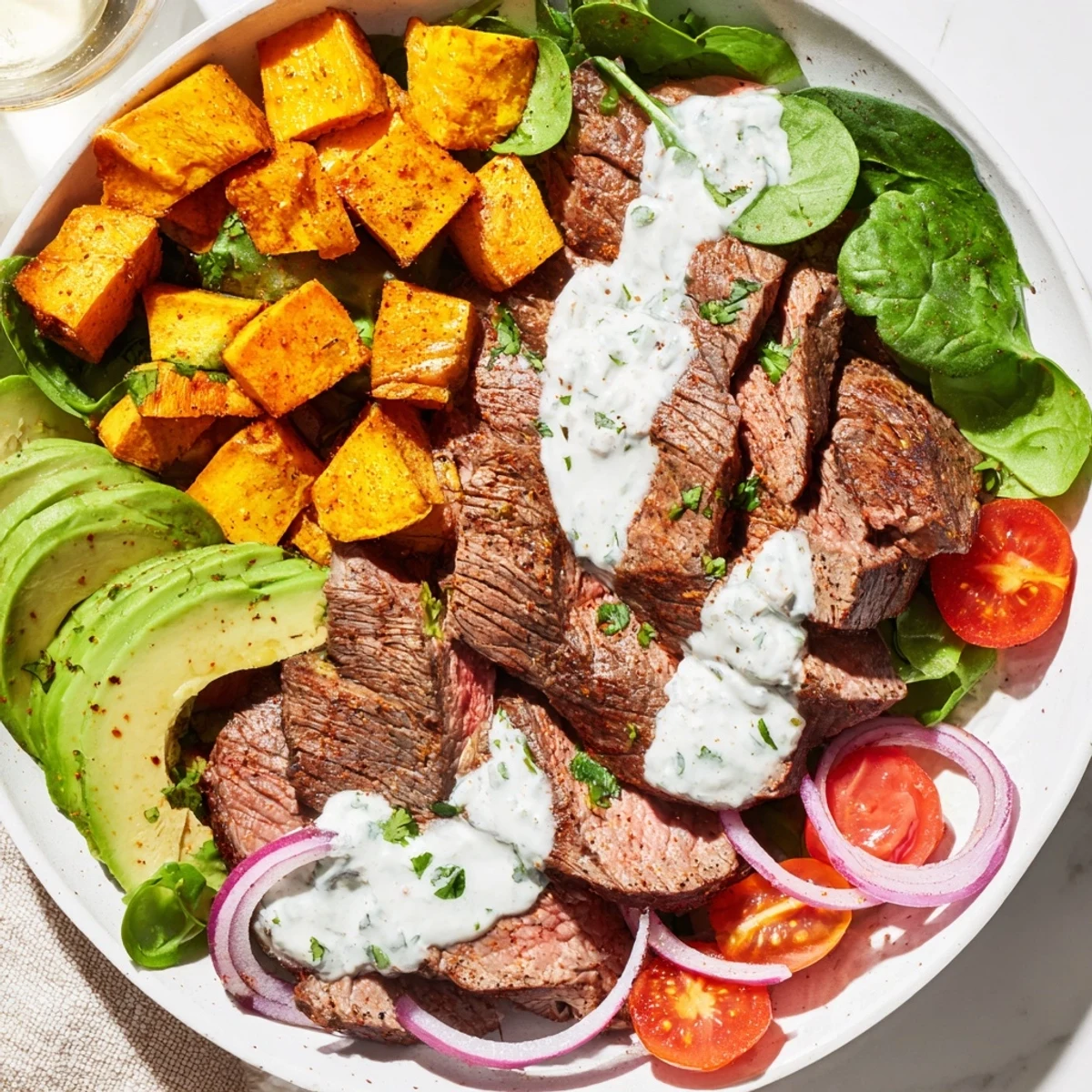 Tender beef avocado sweet potato bowl with vibrant colors and creamy avocado, ready to eat.