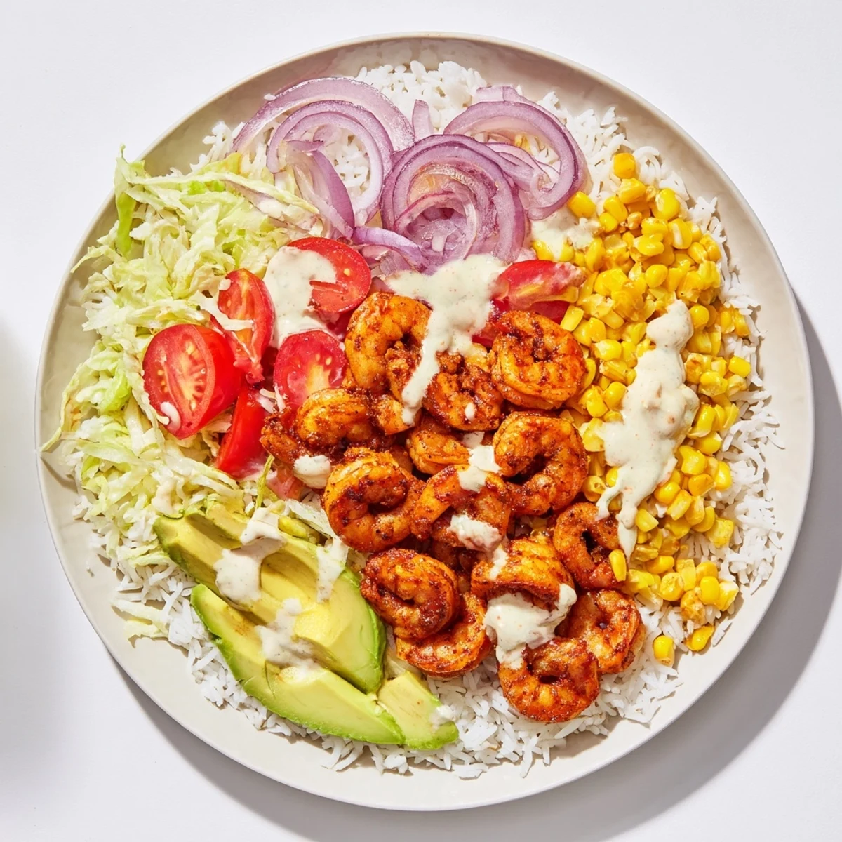 Flavorful Cajun Shrimp Taco Bowls, showcasing seasoned shrimp atop fluffy rice with creamy avocado slices.