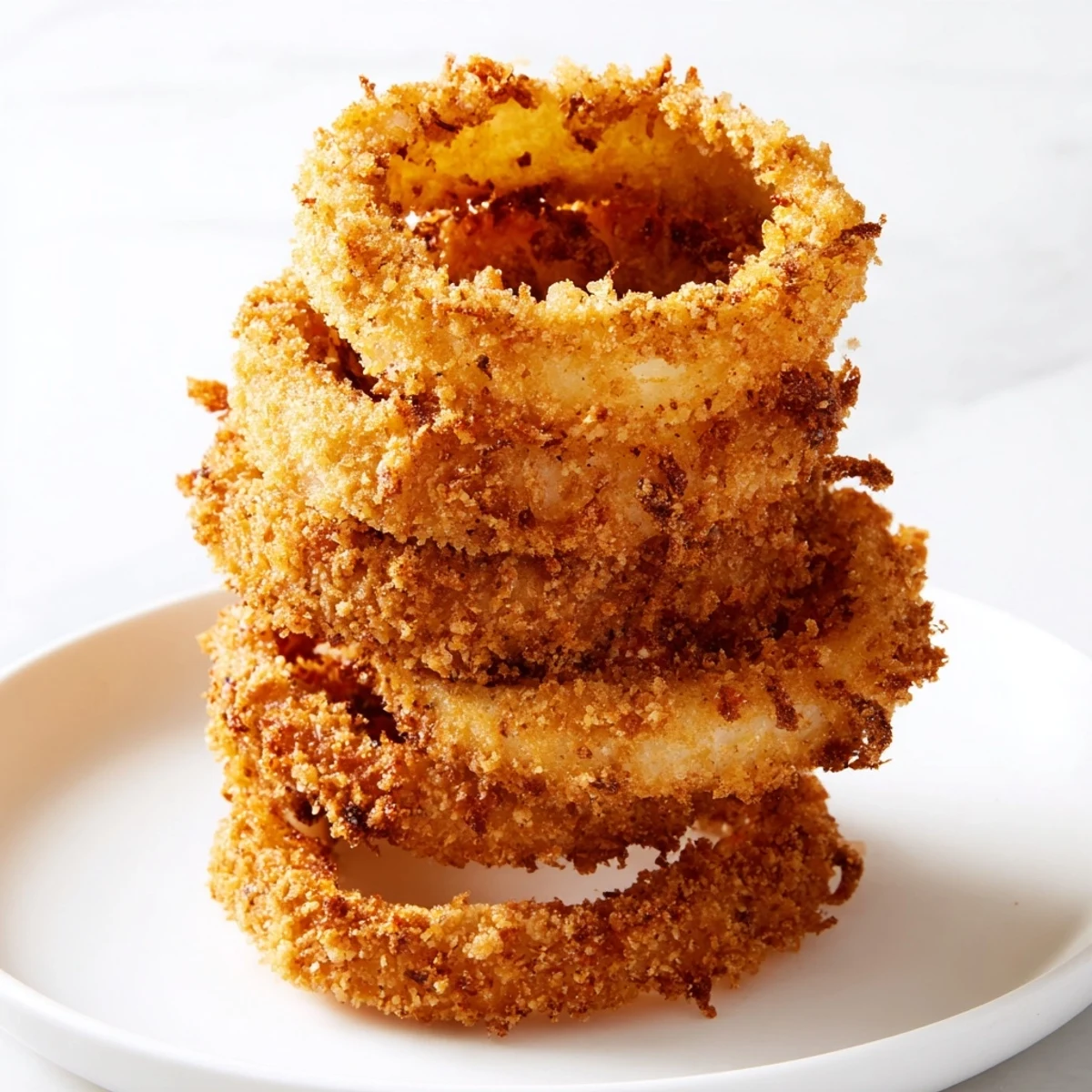 Golden, crispy Crispy Onion Ring Tower, stacked high, ready to be dipped and devoured.