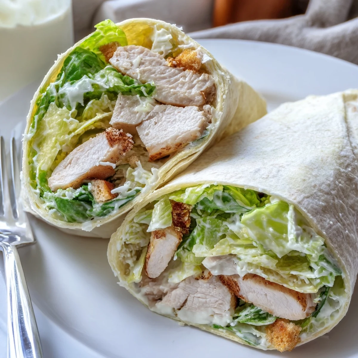Golden grilled chicken slices, crisp romaine lettuce, and shaved parmesan tossed in creamy Caesar dressing, all wrapped in a soft flour tortilla for a handheld meal.
