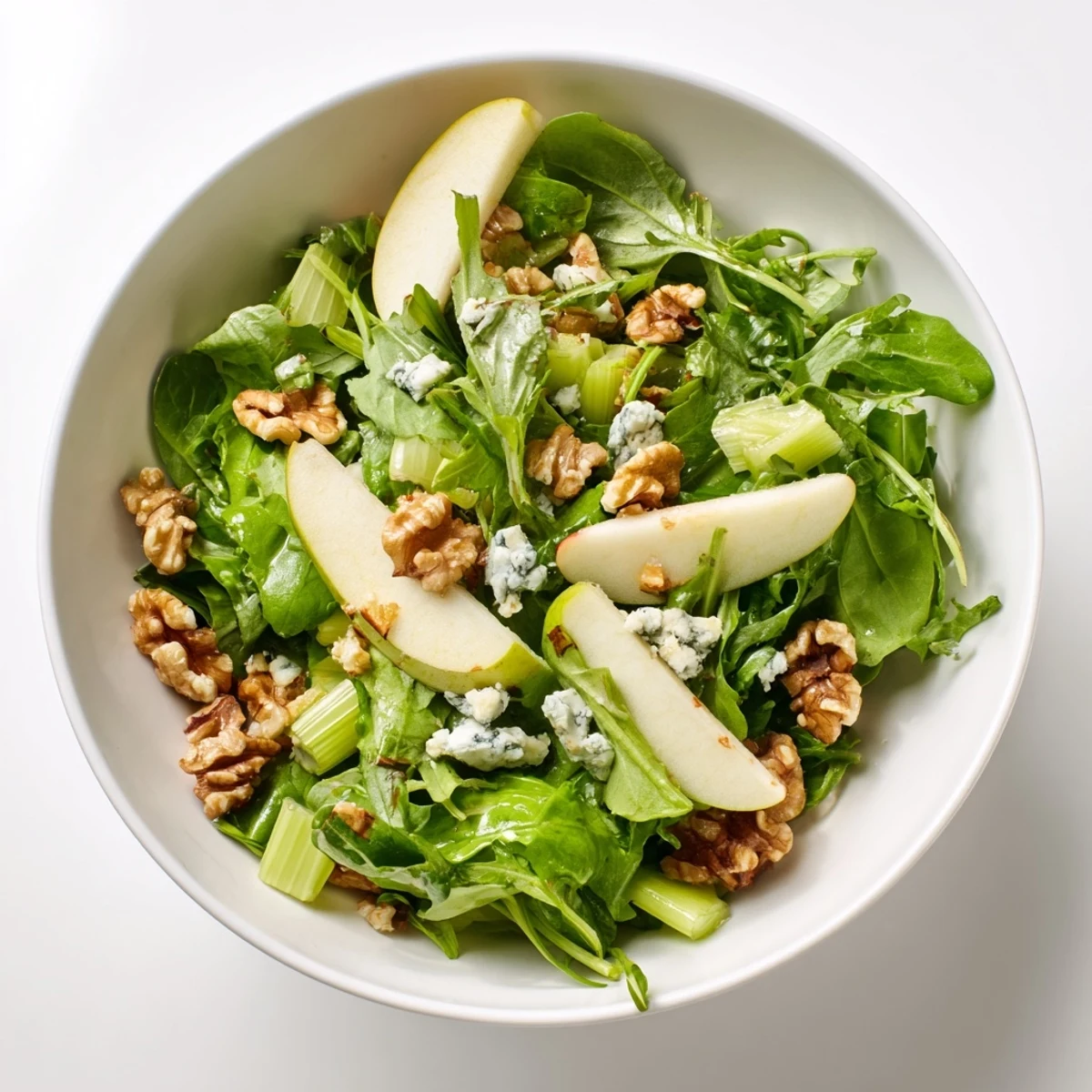 Freshly sliced crisp apples and toasted walnuts tossed with greens in a tangy vinaigrette for this Apple and Walnut Salad.