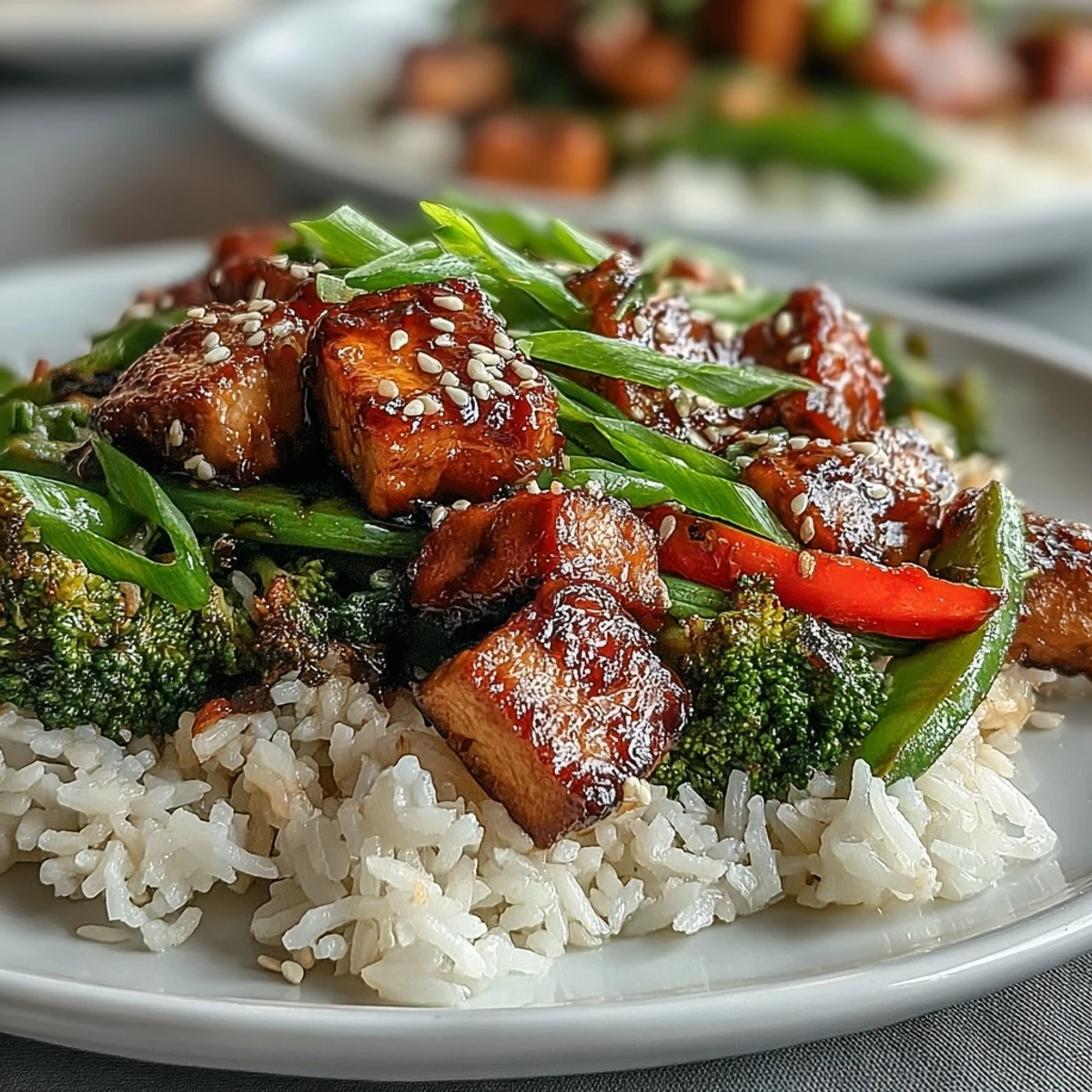 Vibrant teriyaki tofu stir-fry with crispy tofu, broccoli, and snap peas in savory homemade sauce, served over steamed jasmine rice.  