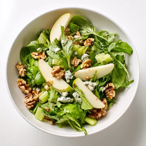 Freshly sliced crisp apples and toasted walnuts tossed with greens in a tangy vinaigrette for this Apple and Walnut Salad.