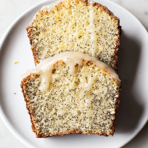 A golden-brown Glazed Lemon Poppy Seed Cake, with a glistening glaze, perfect for dessert or brunch.