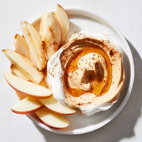Freshly sliced apples and peanut butter dip presented, a delightful snack recipe for anytime.