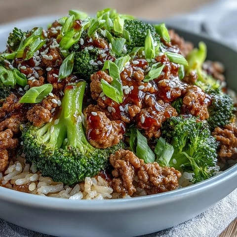 A close-up of Sweet and Spicy Turkey Broccoli Bowls with saucy ground turkey, garlic, ginger, and tender broccoli over rice.
