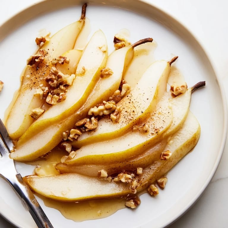 Sweet pear slices topped with a drizzle of honey, ready to enjoy as a light dessert.