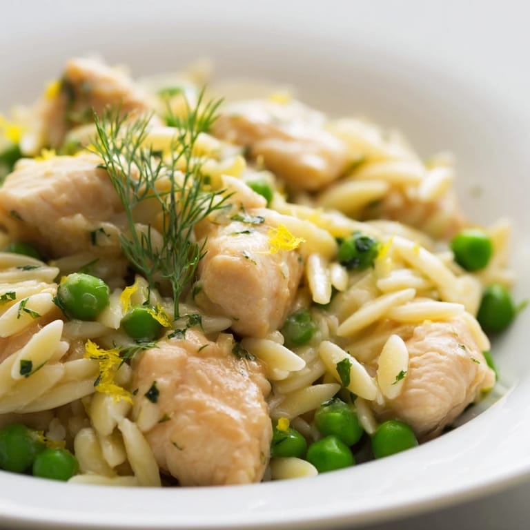 Close-up of a comforting one-pan Lemon Herb Chicken Orzo Skillet, garnished with herbs and served warm for spring.  