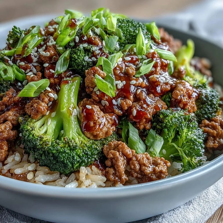 A close-up of Sweet and Spicy Turkey Broccoli Bowls with saucy ground turkey, garlic, ginger, and tender broccoli over rice.