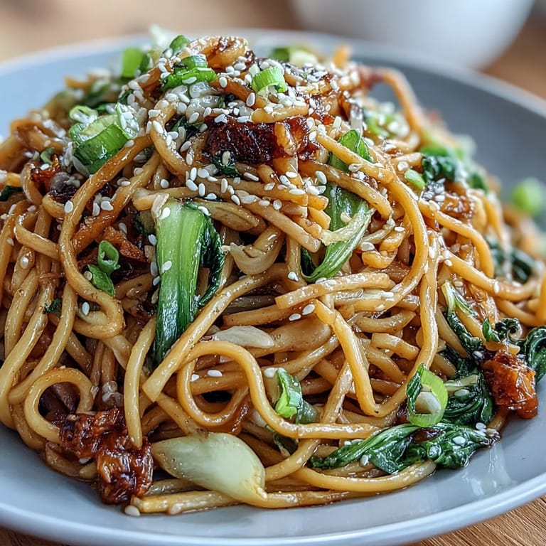 Silky wheat noodles coated in ginger-scallion sauce, served with vibrant sautéed baby bok choy and snap peas.  
