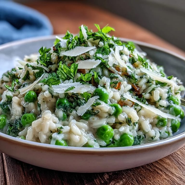 Aromatic spring pea risotto with aged Parmesan and a sprinkle of fresh herbs, perfect for a vegetarian dinner.