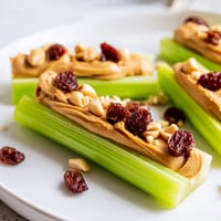 Crisp celery sticks filled with creamy peanut butter, a delightful Peanut Butter Celery Sticks snack.